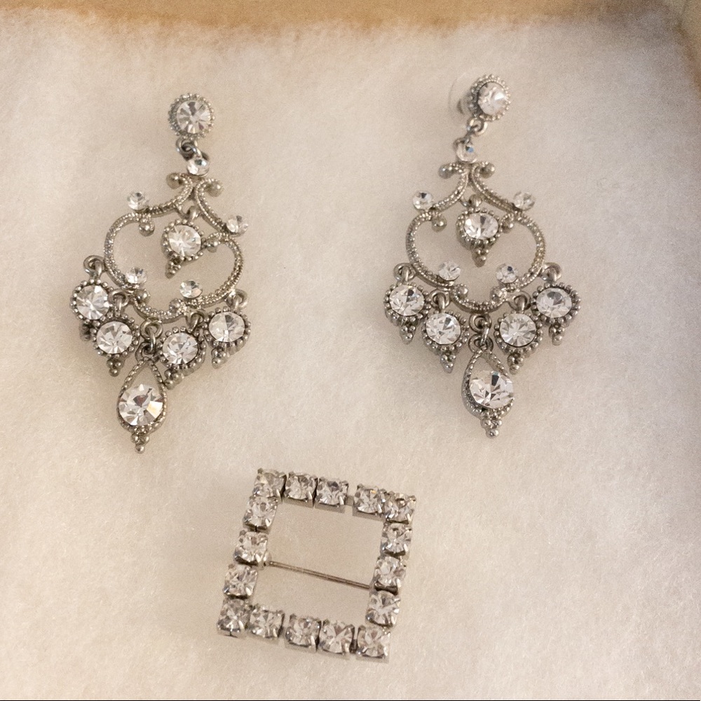 Crystal chandelier earrings and decorative bouquet pin.